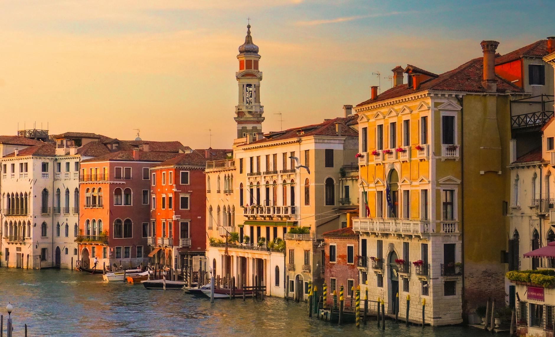 Charming Venetian architecture along a canal at sunset, capturing the essence of Venice, Italy.