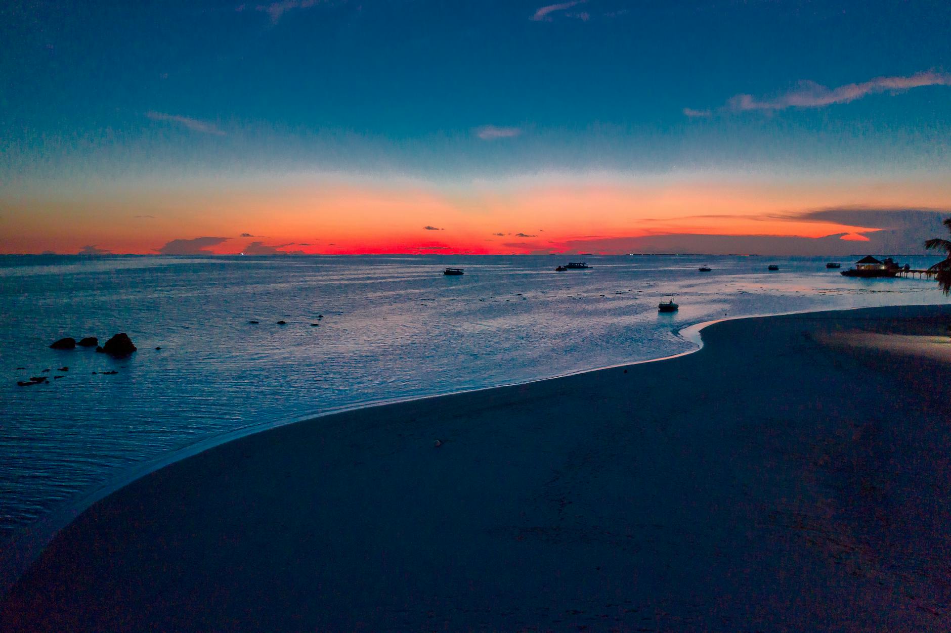 Stunning sunset view at Gaafu Dhaalu Atoll, Maldives, with calm waters and vibrant colors.