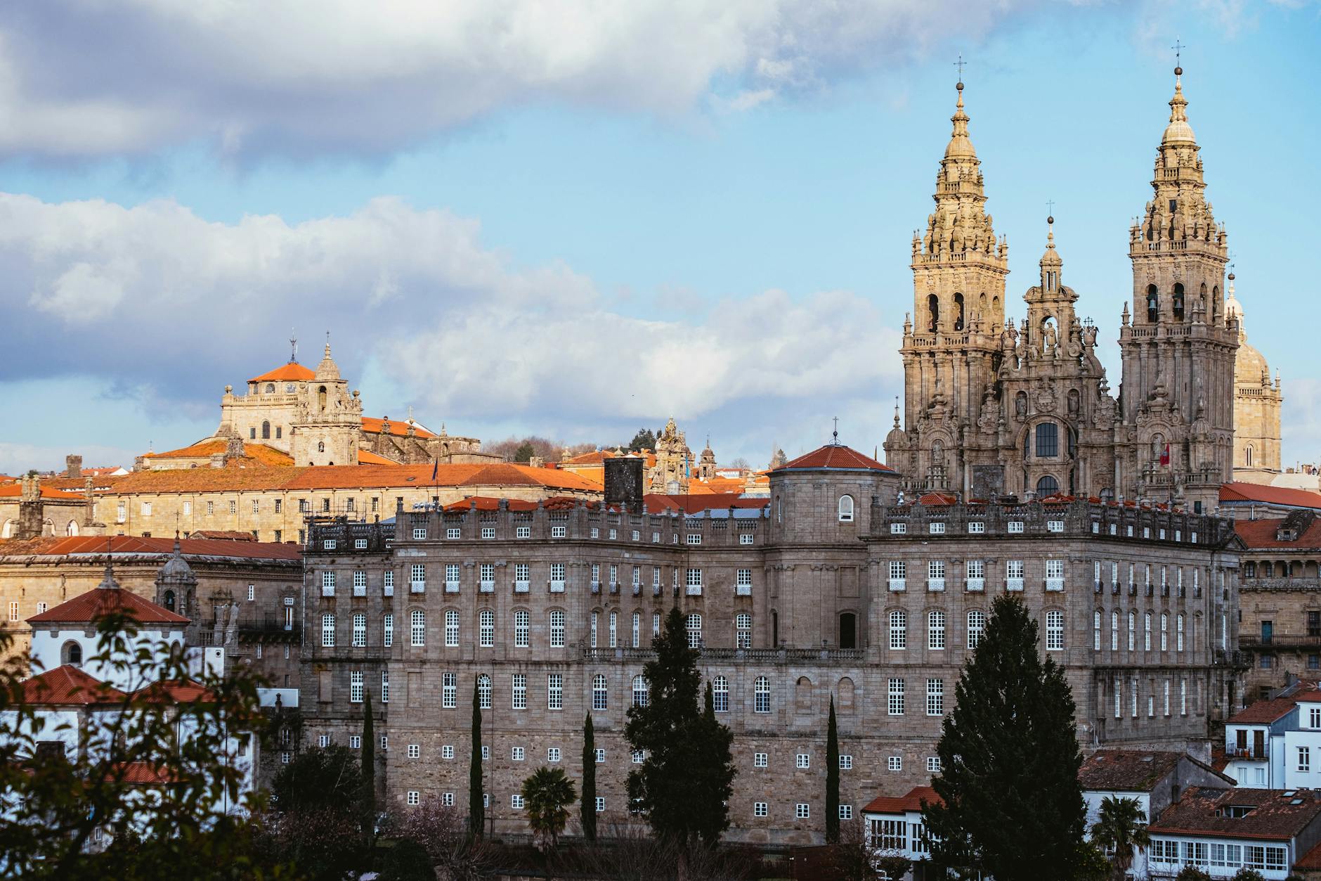 Dramatic view of Santiago de Compostela Cathedral against a blue sky.